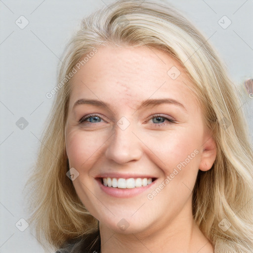 Joyful white young-adult female with long  brown hair and blue eyes