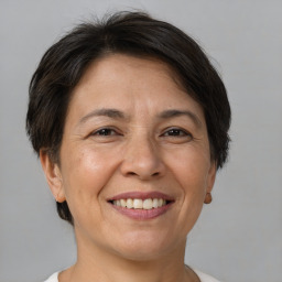 Joyful white adult female with short  brown hair and brown eyes