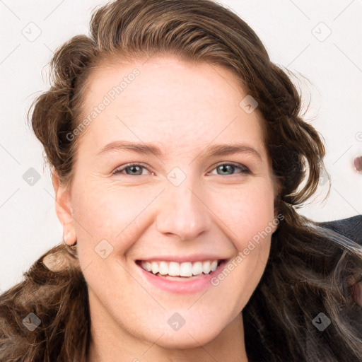 Joyful white young-adult female with long  brown hair and blue eyes