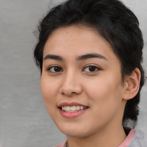 Joyful latino young-adult female with medium  brown hair and brown eyes