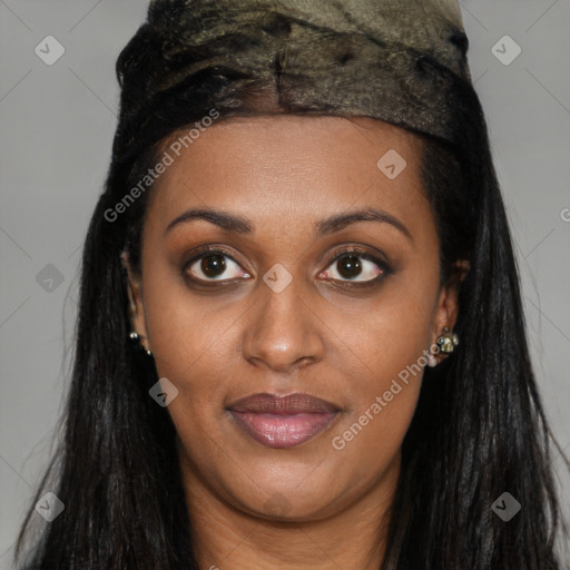 Joyful black young-adult female with long  brown hair and brown eyes