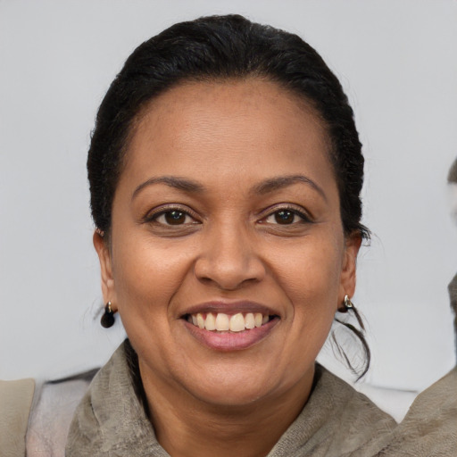 Joyful latino adult female with short  brown hair and brown eyes
