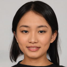 Joyful asian young-adult female with medium  black hair and brown eyes