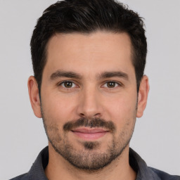 Joyful white young-adult male with short  brown hair and brown eyes