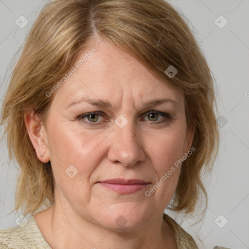 Joyful white adult female with medium  brown hair and blue eyes