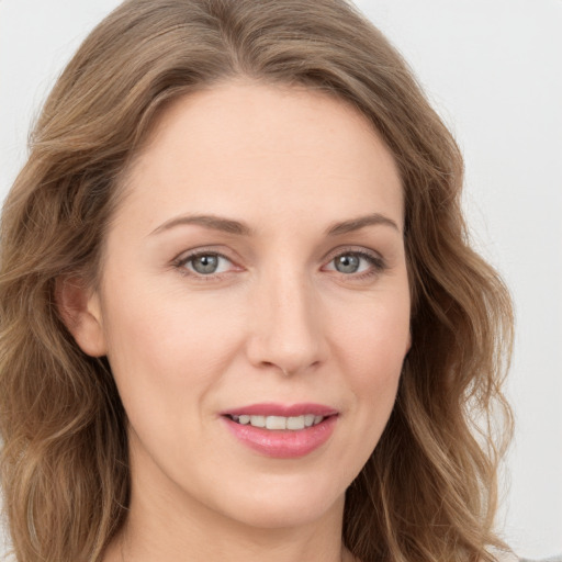 Joyful white young-adult female with long  brown hair and green eyes