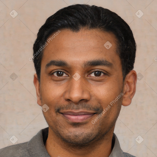 Joyful latino young-adult male with short  black hair and brown eyes