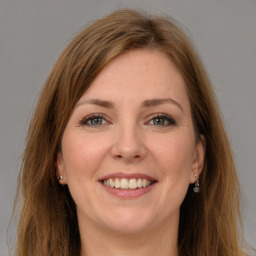 Joyful white young-adult female with long  brown hair and grey eyes