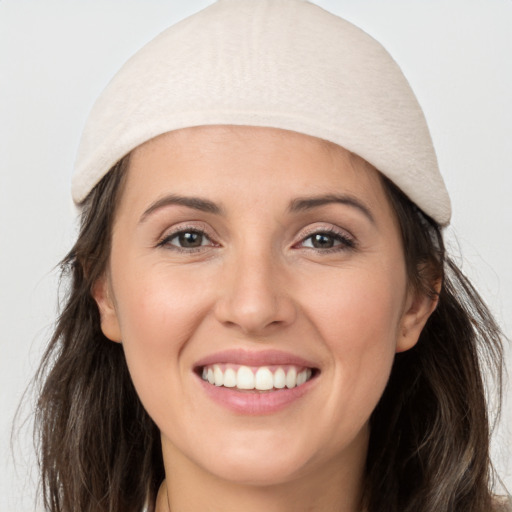 Joyful white young-adult female with long  brown hair and grey eyes