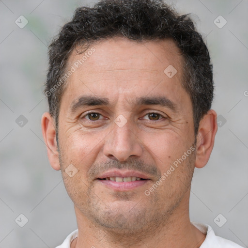 Joyful white adult male with short  brown hair and brown eyes