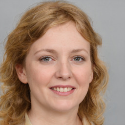 Joyful white young-adult female with medium  brown hair and blue eyes