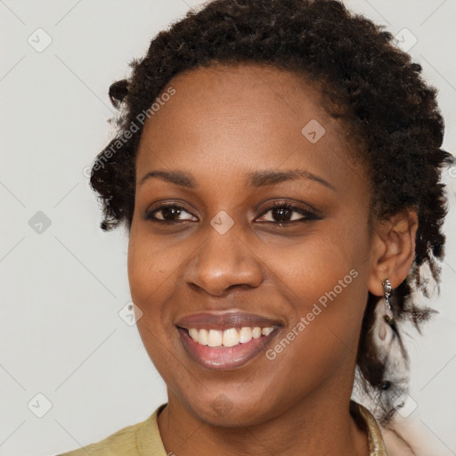 Joyful black young-adult female with long  brown hair and brown eyes