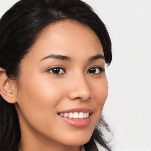 Joyful latino young-adult female with long  brown hair and brown eyes