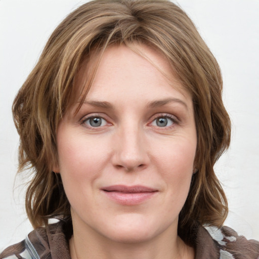 Joyful white young-adult female with medium  brown hair and blue eyes