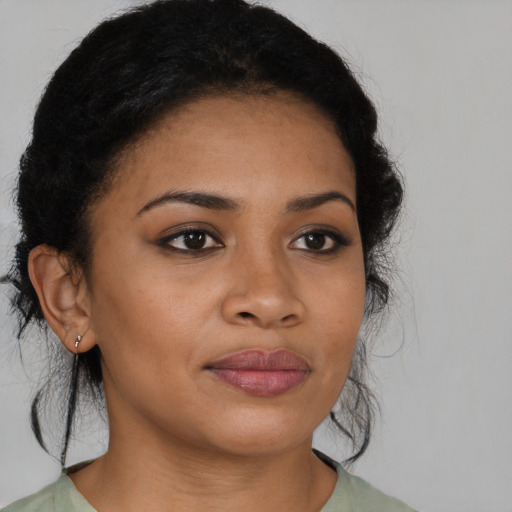 Joyful black young-adult female with medium  brown hair and brown eyes