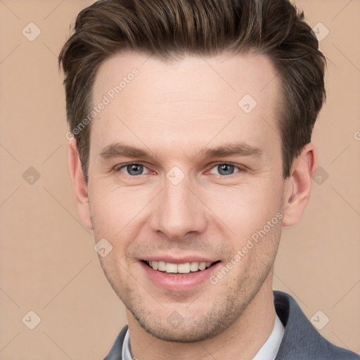 Joyful white young-adult male with short  brown hair and grey eyes