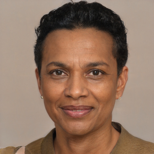 Joyful black adult male with short  black hair and brown eyes