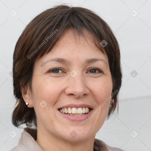 Joyful white adult female with medium  brown hair and brown eyes