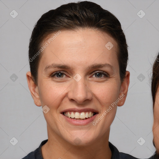 Joyful white young-adult female with short  brown hair and brown eyes