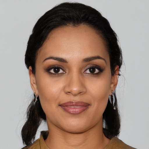 Joyful latino young-adult female with medium  black hair and brown eyes