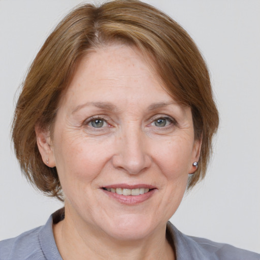 Joyful white adult female with medium  brown hair and grey eyes