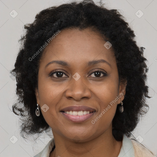 Joyful black young-adult female with long  brown hair and brown eyes