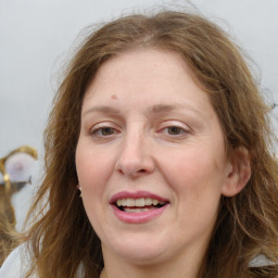 Joyful white adult female with medium  brown hair and blue eyes