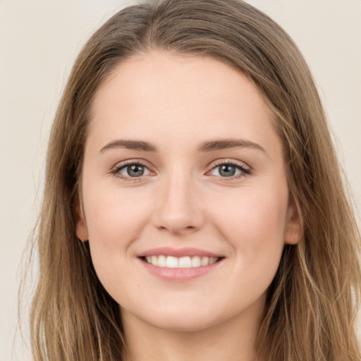 Joyful white young-adult female with long  brown hair and green eyes