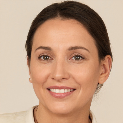 Joyful white adult female with medium  brown hair and brown eyes