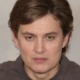 Joyful white adult male with medium  brown hair and brown eyes