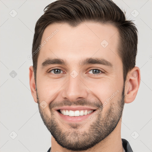 Joyful white young-adult male with short  brown hair and brown eyes