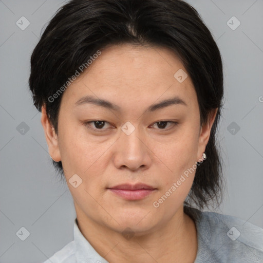 Joyful asian adult female with medium  brown hair and brown eyes