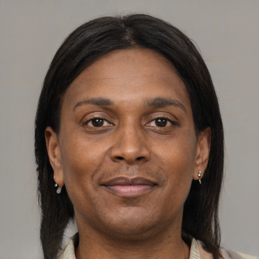 Joyful black adult female with medium  brown hair and brown eyes