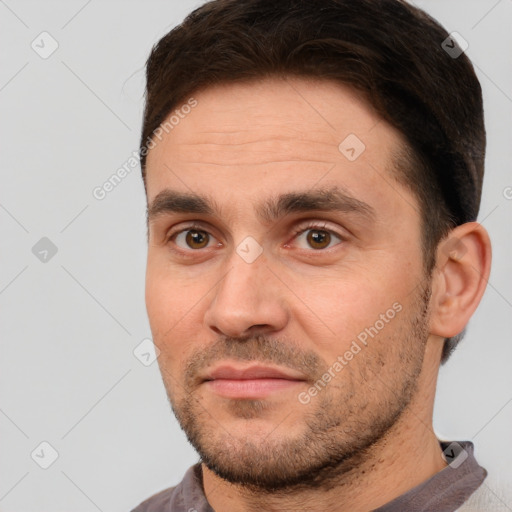 Joyful white adult male with short  brown hair and brown eyes