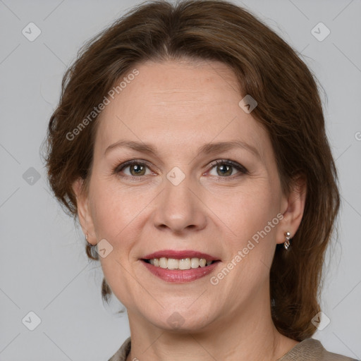 Joyful white adult female with medium  brown hair and grey eyes