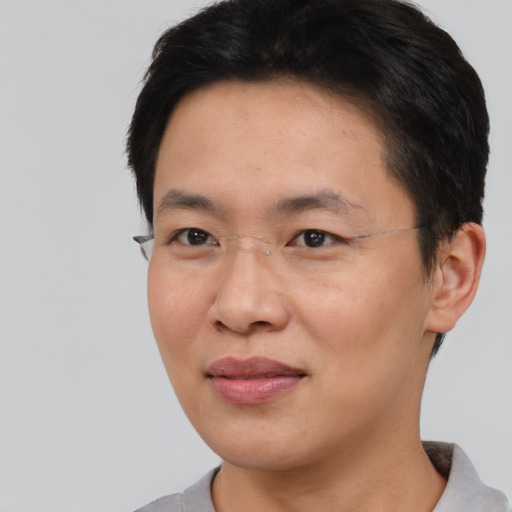 Joyful asian adult male with short  black hair and brown eyes