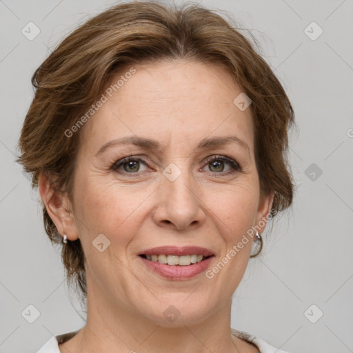 Joyful white adult female with medium  brown hair and grey eyes