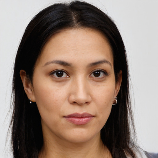 Joyful latino young-adult female with long  brown hair and brown eyes