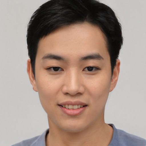 Joyful asian young-adult male with short  black hair and brown eyes