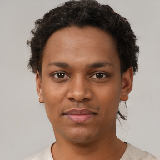 Joyful black young-adult female with short  brown hair and brown eyes