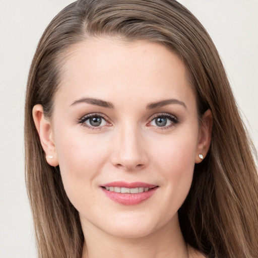 Joyful white young-adult female with long  brown hair and grey eyes