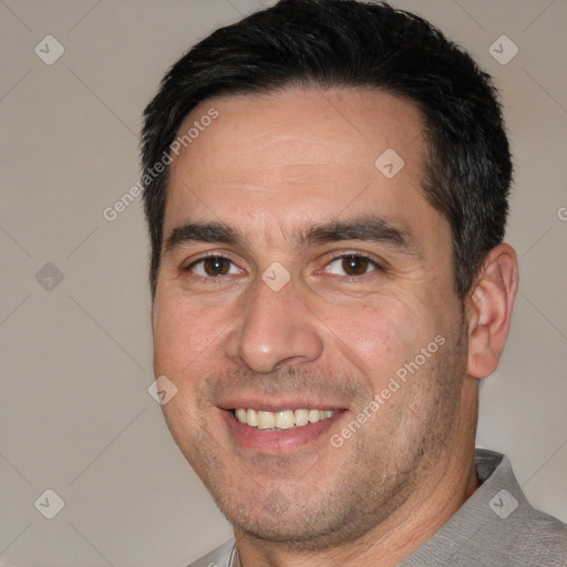 Joyful white adult male with short  black hair and brown eyes