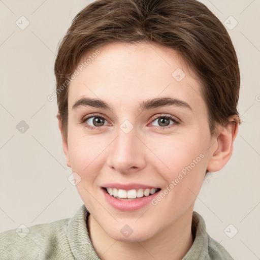 Joyful white young-adult female with short  brown hair and grey eyes