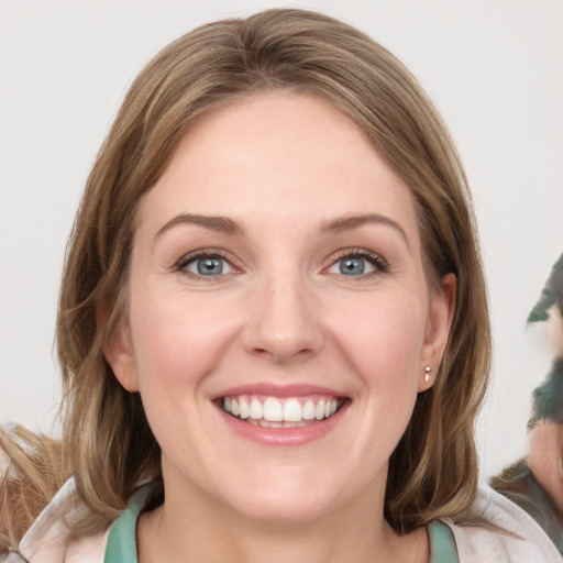 Joyful white young-adult female with medium  brown hair and blue eyes