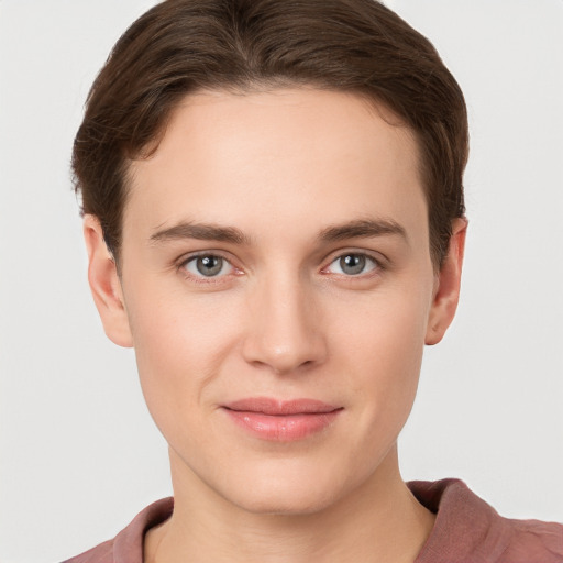 Joyful white young-adult female with short  brown hair and grey eyes