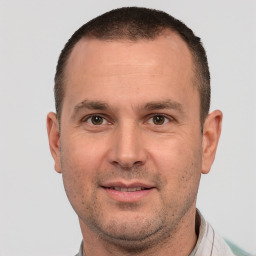 Joyful white adult male with short  brown hair and brown eyes