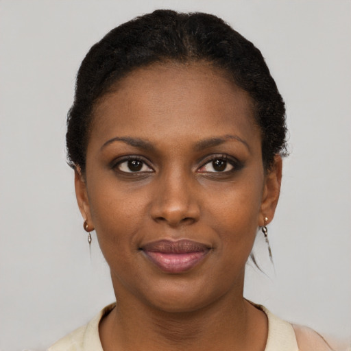 Joyful black young-adult female with short  brown hair and brown eyes