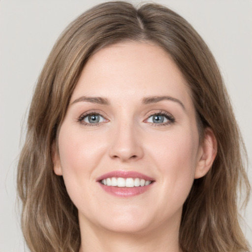 Joyful white young-adult female with medium  brown hair and green eyes