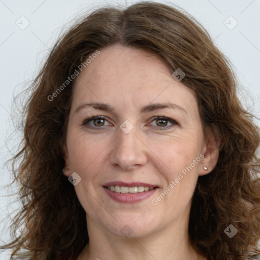 Joyful white adult female with long  brown hair and grey eyes