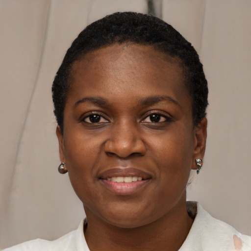 Joyful black young-adult female with short  black hair and brown eyes